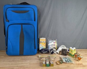 lot 161 image: Assortment of Blue Suitcase, Blow Dryer, Stretch Bands, Spa Naturals Vitamin E Oil, Low Back Bra Straps, Wood Clothes Pins, Beauty Guru Natural Serums and More B