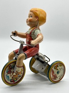 lot 128 image: Vintage Tin Wind Up Kiddy Cyclist by Unique Art Mfg.