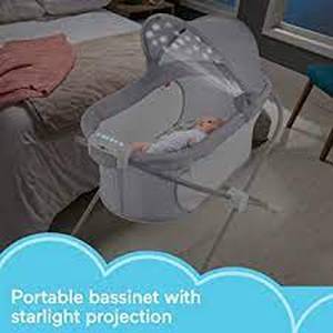 lot 44 image: Fisher-Price Portable Baby Bedside Sleeper, Soothing View Projection Bassinet with Lights Music Sounds and Vibrations