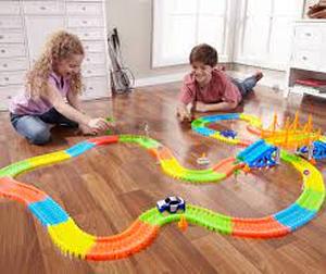 lot 55 image: Magic Tracks Deluxe Kit w 68 Accessories, 20 Glow-in-the-Dark Track & 2 Race Cars  Extra Parts & Accessories, Multi Set