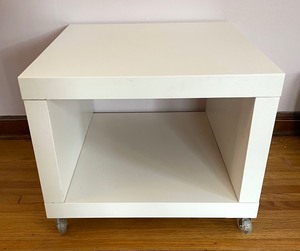 lot 23 image: Petite White Accent Cube Table on Casters