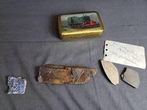 Tin with Rock and Pottery from Overseas