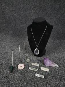 lot 1130 image: Lot of Crystals - Amethyst Point, Bloodstone Pendulum, Rose Quartz Pendant, Clear Quartz Caged Pendant, Clear Quartz Teardrop Pendant, and (4) Quartz Points