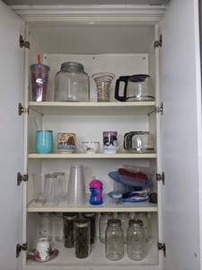 A Collection of Kitchen Items Including Glasses, Jars and More