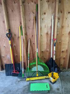 A Variety of Gardening Tools Including Rakes, Shovels, a Spreader and More