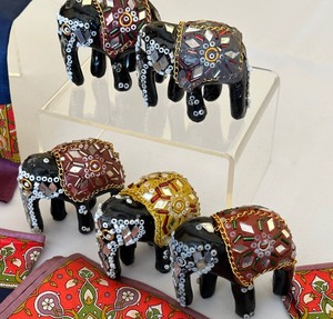 lot 112 image: Collection of Bejeweled Elephants  Elephant Motif Napkin Set  Elephant Print Enamel Plate
