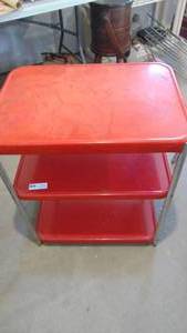 lot 5 image: Red cart, no wheels, top has some wear
