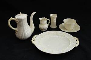 lot 36 image: Belleek Ireland Porcelain Pitcher, Creamer, Platter, Teacup & Saucer, and Bud Vase