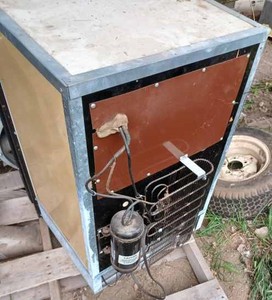 lot 154 image: Norcold Electric Refrigerator for Camper or Dorm Room, Mini Electric Refrigerator, and Two Cooler Type Upright Ice Boxes
