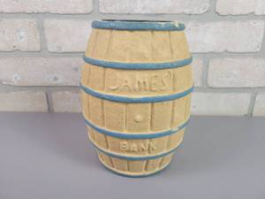 lot 53 image: 1940s James Candy Barrel Coin Bank - Pressed Fiber Material