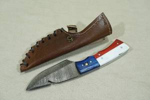 lot 81 image: Damascus Style Blade Hunting Knife with Red, White, and Blue Handle