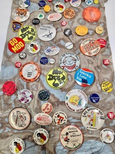 lot 264 image: Awesome Vintage 1960s era Estate Lot of Groovy Pinbacks Buttons on Fabric