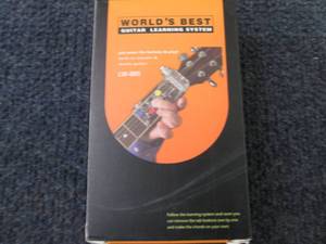lot 63 image: Worlds Best Guitar Learning System...