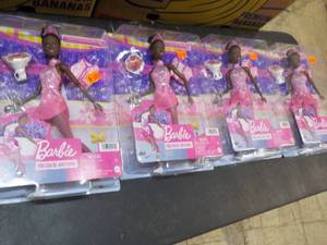 4 Barbie Dolls...