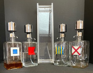 lot 88 image: Vintage Set of 4 Nautical Flag Themed Glass Liquor Pump Dispenser with Lucite Stand