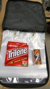 lot 252 image: Soft sided bait bag with 9 pages in it, 12 lb fishing line and a silver blue rapala