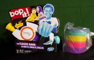 lot 75 image: Bop It Classic Game  Large Plastic Slinky