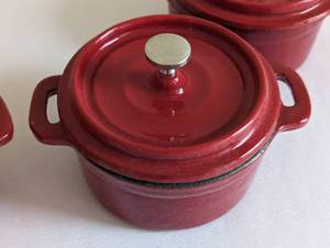 lot 51 image: Set of Four Wolfgang Puck Red Mini Cast Iron Dutch Ovens