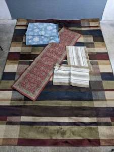 An Assortment of Various Sized Rugs   C
