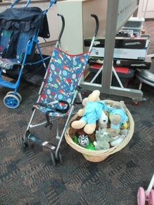 lot 108 image: COSCO STROLLER WITH STUFFED ANIMALS