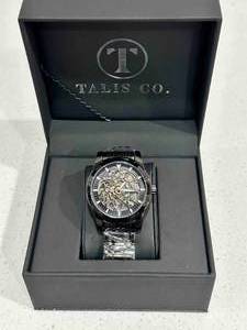 lot 1 image: Brand New Talis Co. Black Skeleton Watch $729 Retail