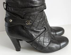 lot 57 image: Chanel Black Leather Knee High Boots