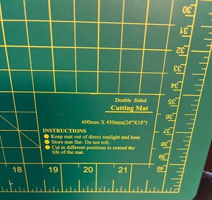 lot 391 image: Fiskars Cutting Ruler and Double Sided Cutting Board Mat