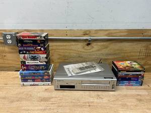 lot 21 image: SYLVANIA DVD Player with Video Cassette Player with DVD and VHS Movie Collection
