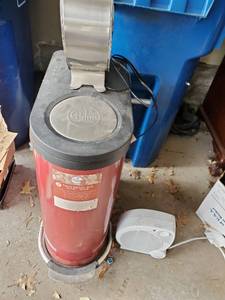 Red, Dual Bin Trash Can by Palms, Space Heater, and Small Fan