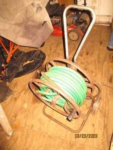 lot 58 image: Metal hose reel on wheels with atta...