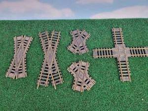 lot 694 image: (5) HO Scale Brass  Nickel-Silver Crosses - (1) 25° - NS, (1) 30°, (2) 60° & (1) 90°
