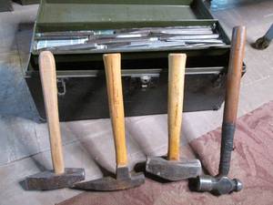 Toolbox filled with hammers and chi...