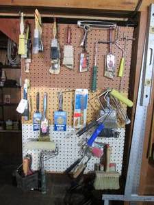 Pegboard wall filled with paint bru...