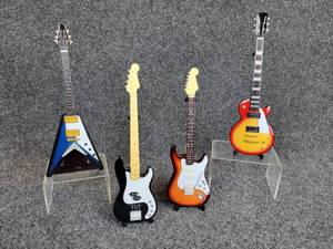 lot 218 image: Lot of (4) Miniature Electric & Acoustic Guitars on Stands