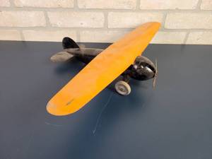 lot 2301 image: Antique WYANDOTTE Pressed Steel Airplane Toy - Wood Wheels