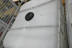 Smaller Poly tank in cage 1000 gal