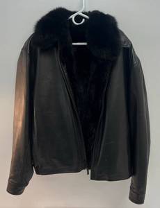 lot 19 image: Vintage Andrew Mark New York Leather Jacket Size L With Zip Out Fur Liner (Liner Zipper Has Loose Spot And One Snap At Top Of Liner Broke)