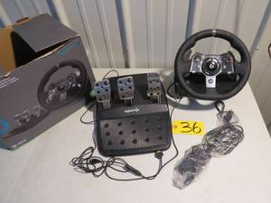 lot 36 image: Logitech G920 Driving Force Racing Wheel and Floor Pedals, Real Force Feedback, Stainless Steel Paddle Shifters, Leather Steering Wheel Cover for Xbox Series XS, Xbox One, PC, Mac - Black