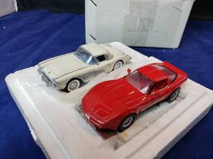 lot 26 image: 1960 and 1980 4 Danbury Mint Corvettes with Display Stand