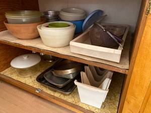 lot 148 image: Contents of Kitchen Cabinet Strainers, Cake & Pie Pans, Mixing Bowls and More