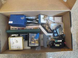 Shoebox full of assorted jewelry in...
