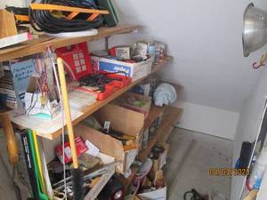 Garage goodies on wall shelves (not...