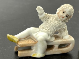lot 65 image: Antique Victorian Snow Baby with Sled and Antique Victorian Snow Baby with Skis