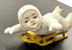 lot 68 image: Antique Victorian Snow Baby on Metal Sled