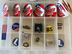 lot 80 image: menagerie of retro political buttons, pins, and stickers in plastic sorting case