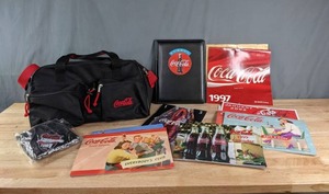 lot 59 image: Coca-Cola Memorabilia Calendars, Duffle Bag, Inflatable Football and Leather Portfolio U