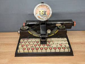 lot 54 image: Vintage Marx Tin Toys De-Luxe Dial Typewriter Toy W
