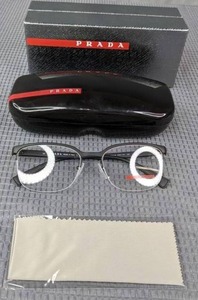 lot 28 image: New Prada Eyeglass Frames with Display Lenses, Case and Cleaning Cloth  L