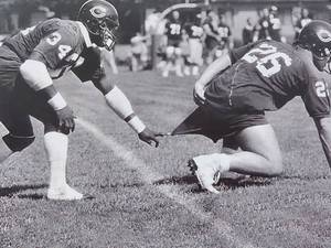 lot 100 image: Photo of Chicago Bears Walter Payton Pranking Matt Suhey by Photographer Walt Barry