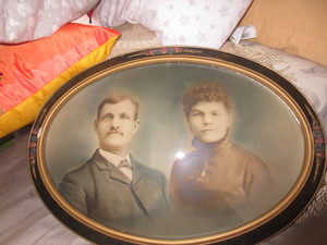 lot 926 image: ANTIQUE OVAL FRAME WITH RAISED FLORAL DESIGN AND HAND TINTED PHOTO